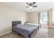 Bedroom with two twin beds, neutral carpet, and a window providing natural light at 3424 E Harmony Ave, Mesa, AZ 85204