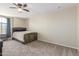 Cozy bedroom with carpet, a ceiling fan, and a bed against the wall at 3424 E Harmony Ave, Mesa, AZ 85204
