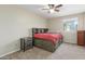 Bedroom showcasing a bed with built-in storage, accompanied by matching nightstands at 3424 E Harmony Ave, Mesa, AZ 85204