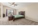 Bedroom features a ceiling fan, large window, and neutral carpeting at 3424 E Harmony Ave, Mesa, AZ 85204