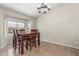 Dining room with a wooden table, chandelier, and tile flooring at 3424 E Harmony Ave, Mesa, AZ 85204