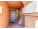 Covered front porch entry featuring tile flooring, a chair, and a plant at 3424 E Harmony Ave, Mesa, AZ 85204