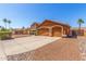 A home with a three-car garage, desert landscaping, and a beautiful facade at 3424 E Harmony Ave, Mesa, AZ 85204