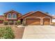 Two-story home with a three-car garage and desert landscaping at 3424 E Harmony Ave, Mesa, AZ 85204