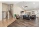 Open-concept living room with wood floors, high ceilings, and neutral paint at 3424 E Harmony Ave, Mesa, AZ 85204