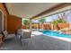 Relax on the patio overlooking the beautiful private pool with cascading water feature and gazebo at 3424 E Harmony Ave, Mesa, AZ 85204