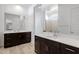 Elegant bathroom featuring dual vanities with sleek countertops and large mirrors at 3885 E Kenley Ln, San Tan Valley, AZ 85143