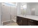 Elegant bathroom featuring a frameless glass shower and a modern vanity with dark wood cabinets and quartz countertop at 3885 E Kenley Ln, San Tan Valley, AZ 85143