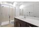 Modern bathroom features a glass shower and vanity with dark wood cabinets and quartz countertop at 3885 E Kenley Ln, San Tan Valley, AZ 85143