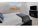 Bright bedroom featuring a cozy bed, fireplace and a window view at 3885 E Kenley Ln, San Tan Valley, AZ 85143