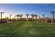 Community park with green space, walking paths, benches, and string lights at sunset at 3885 E Kenley Ln, San Tan Valley, AZ 85143