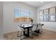 Bright dining room with a long black table, six chairs, and artwork, perfect for Gathering gatherings at 3885 E Kenley Ln, San Tan Valley, AZ 85143