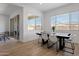 Bright dining room featuring a modern table, stylish chairs, and natural light from large windows at 3885 E Kenley Ln, San Tan Valley, AZ 85143