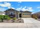 Charming single-Gathering home with a two-car garage and stone accents at 3885 E Kenley Ln, San Tan Valley, AZ 85143