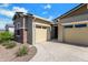 Charming home with a two-car garage, complemented by lush landscaping at 3885 E Kenley Ln, San Tan Valley, AZ 85143