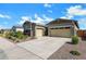Well-maintained front exterior with mature landscaping and a spacious driveway at 3885 E Kenley Ln, San Tan Valley, AZ 85143
