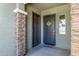Inviting entryway featuring decorative wreath, stone accents, and convenient small window at 3885 E Kenley Ln, San Tan Valley, AZ 85143