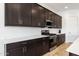 Elegant kitchen with sleek countertops, stainless steel appliances, and dark wood cabinetry at 3885 E Kenley Ln, San Tan Valley, AZ 85143