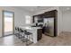 Bright kitchen featuring an island with a quartz countertop and bar seating, complemented by stainless-steel appliances at 3885 E Kenley Ln, San Tan Valley, AZ 85143