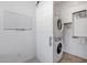 Functional laundry room with stacked washer and dryer, a sliding barn door, and closet space for storage at 3885 E Kenley Ln, San Tan Valley, AZ 85143