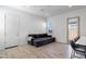 Bright living room with a comfortable sofa, a stylish door and a window view at 3885 E Kenley Ln, San Tan Valley, AZ 85143
