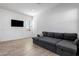 Cozy living room featuring a modern sofa and a wall-mounted TV at 3885 E Kenley Ln, San Tan Valley, AZ 85143