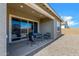 Cozy covered patio with stylish outdoor furniture, perfect for relaxing and entertaining guests at 3885 E Kenley Ln, San Tan Valley, AZ 85143