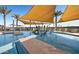 Community splash pad and pool area featuring sun shades and palm trees at 3885 E Kenley Ln, San Tan Valley, AZ 85143