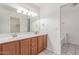 Bathroom featuring double sinks, modern lighting, and tile floors at 4110 W Villa Linda Dr, Glendale, AZ 85310