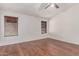 Bedroom with wood-look flooring, ceiling fan, and two windows with blinds at 4110 W Villa Linda Dr, Glendale, AZ 85310