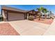 Well-maintained single-Gathering home with a spacious driveway, desert landscaping, and an attached garage at 4110 W Villa Linda Dr, Glendale, AZ 85310