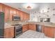 Functional kitchen with wooden cabinets, granite countertops, stainless steel appliances, and an open layout at 4110 W Villa Linda Dr, Glendale, AZ 85310