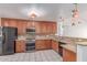 Well-equipped kitchen featuring wooden cabinets, granite countertops, and stainless steel appliances at 4110 W Villa Linda Dr, Glendale, AZ 85310