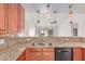 The kitchen features ample countertop space with a breakfast bar that overlooks an airy living space at 4110 W Villa Linda Dr, Glendale, AZ 85310