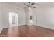 Spacious living room boasting wood-look floors, a ceiling fan, and access to other rooms at 4110 W Villa Linda Dr, Glendale, AZ 85310