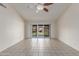 Bright living room featuring tile flooring, ceiling fan, and sliding glass door to the backyard at 4110 W Villa Linda Dr, Glendale, AZ 85310