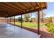 This covered patio offers tranquil views of the lush green lawn and mature landscaping at 4110 W Villa Linda Dr, Glendale, AZ 85310
