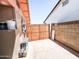 Enclosed backyard features a wooden gate, an A/C unit, and concrete paving at 4623 W Mission Ln, Glendale, AZ 85302