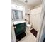 Bathroom features a dark green vanity, toilet and a shower with a curtain at 4623 W Mission Ln, Glendale, AZ 85302