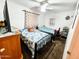 Bedroom features 2 beds, ceiling fan, and patterned curtains at 4623 W Mission Ln, Glendale, AZ 85302