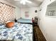 Bedroom features 2 beds, ceiling fan, and patterned curtains at 4623 W Mission Ln, Glendale, AZ 85302
