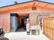 Garage exterior with access door, storage cabinets, and an air conditioning unit at 4623 W Mission Ln, Glendale, AZ 85302