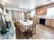 Kitchen and dining area featuring natural wood cabinets, stainless steel appliances, and modern tile flooring at 4623 W Mission Ln, Glendale, AZ 85302