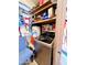 Functional laundry area features a modern washer, storage shelves, and a vibrant piñata at 4623 W Mission Ln, Glendale, AZ 85302