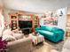 Open living area with tiled floors, an entertainment center, and a comfortable seating arrangement at 4623 W Mission Ln, Glendale, AZ 85302