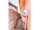 Narrow side yard with gravel and utility boxes at 4623 W Mission Ln, Glendale, AZ 85302