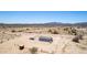 Aerial view of rural home with its large lot and surrounding desert landscape at 52680 W Meadow Green Rd, Maricopa, AZ 85139