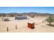 Desert home aerial view showcasing the outbuildings and landscape at 52680 W Meadow Green Rd, Maricopa, AZ 85139