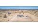 Aerial view of home and desert landscape, surrounded by fence and outbuildings at 52680 W Meadow Green Rd, Maricopa, AZ 85139