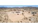 An aerial shot showing a home in a desert landscape with open space and horizon views at 52680 W Meadow Green Rd, Maricopa, AZ 85139